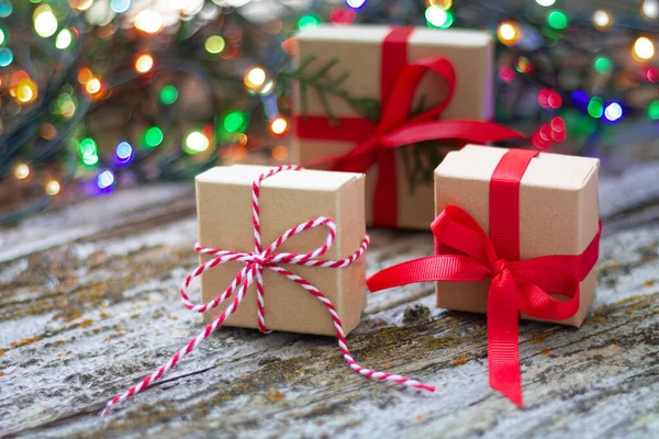 Gift boxes against a background bokeh of twinkling party lights. Christmas or New Year presents