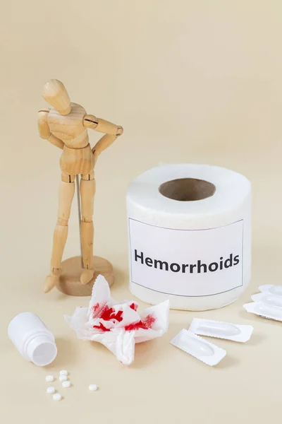 Hemorrhoids concept. Wooden man feel pain because of anus problems