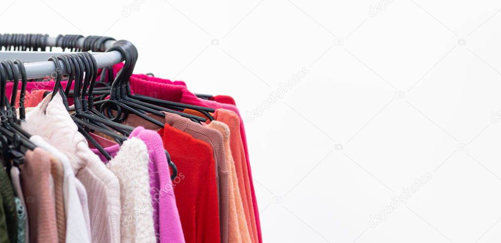 Different female clothes on hangers. Sale concept