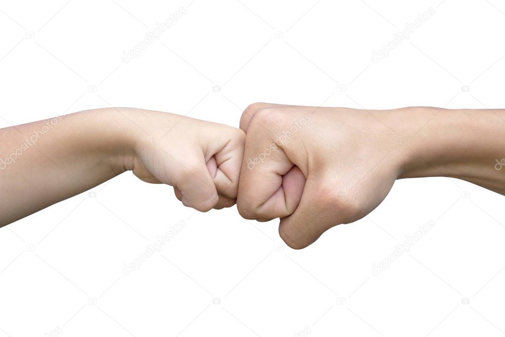 Power five, fist bump or brofist. Close-up of child and father fists touching each other