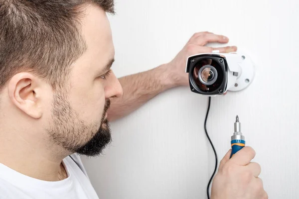 Technician worker installing video surveillance camera