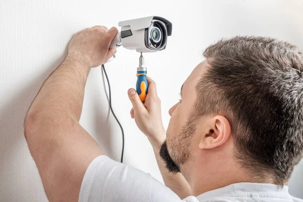 Technician worker installing video surveillance camera