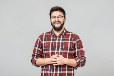 Young handsome male with beard against gray background