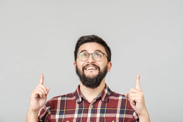 Beautiful bearded guy pointing up