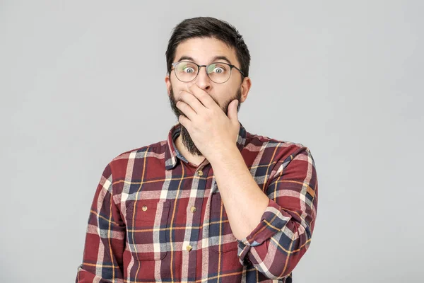 Thrilled excited guy in glasses isolated over gray — Stock Photo, Image