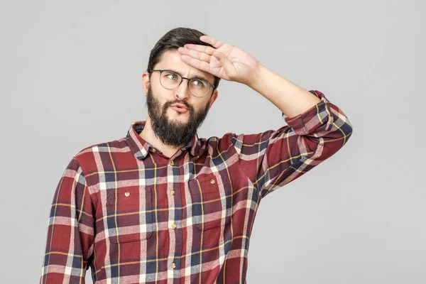 Portrait of young tired caucasian guy wiping his forehead with h — Stock Photo, Image