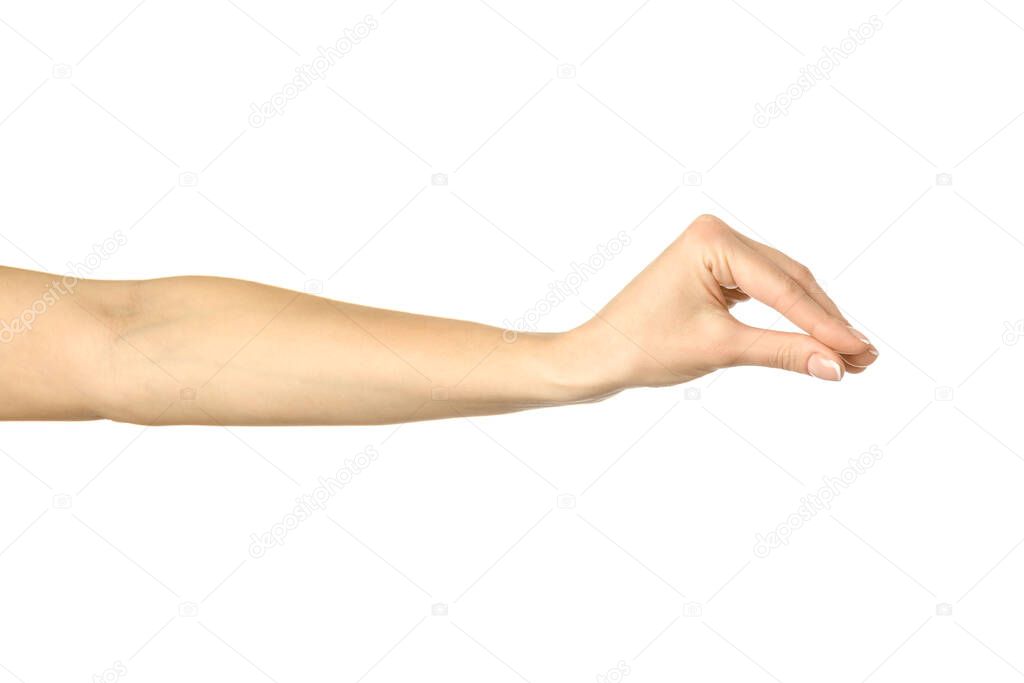 Measuring invisible item. Woman hand with french manicure gesturing isolated on white background. Part of series