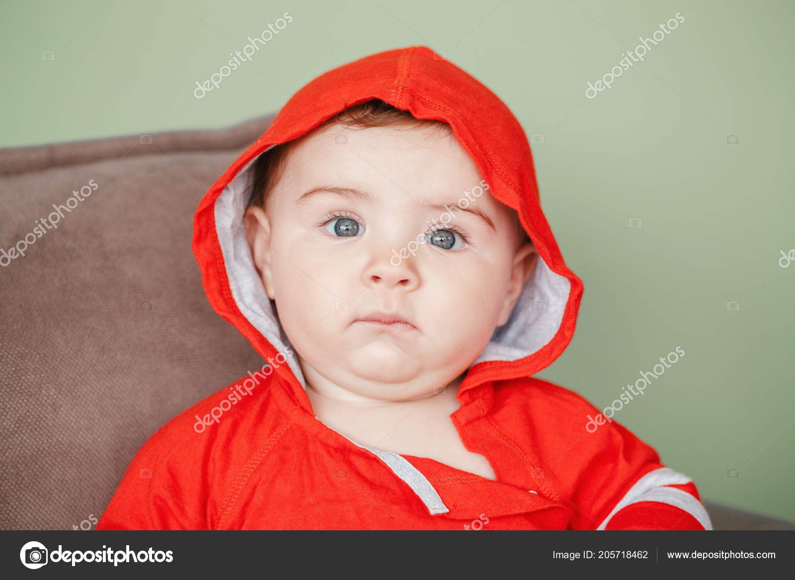 Portrait of cute adorable Caucasian baby boy with black eyes in