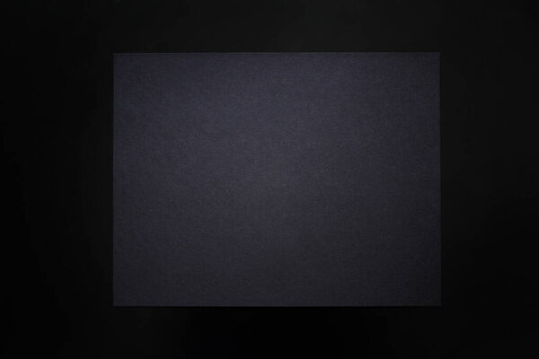 Black dark piece of paper background mock-up with copyspace. Toned grunge retro vintage wallpaper with cardboard texture surface. Blackout Tuesday concept. Black lives matter support.