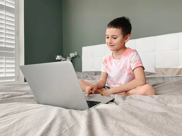 Caucasian Boy Child Sitting Bed Learning Online Laptop Internet Virtual — Stock Photo, Image