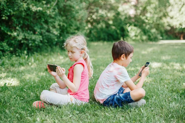 Мальчик Девочка Играют Игры Смартфонах Открытом Воздухе Детская Зависимость Экранов — стоковое фото