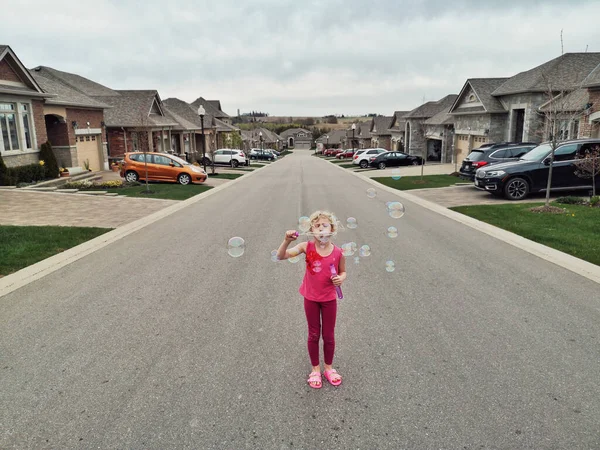 Young Caucasian Girl Blowing Soap Bubbles Residential Area Street Road — Stock Photo, Image