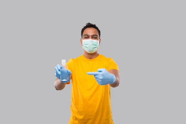 Indian Man pekar på händerna Sanitizer bär medicinsk mask och handskar isolerad. Indisk man håller handen antiseptisk — Stockfoto