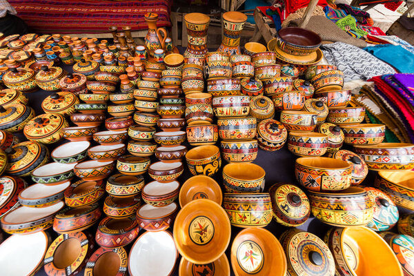 Colorful pottery in a craft market of Pisac, near Cusco, in Peru