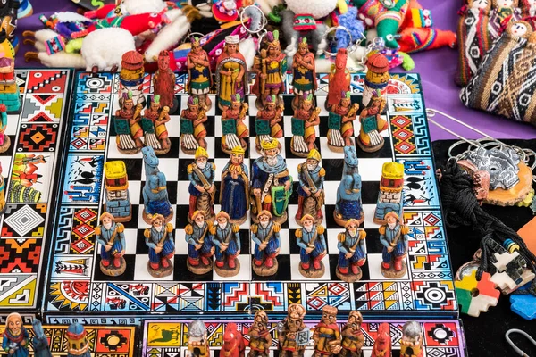 The traditional chess game art and craft product with Spanish against Inca people on a local handicraft market in Pisac, near Cusco, Peru