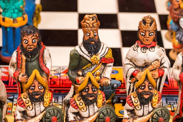 The traditional chess game art and craft product with Spanish against Inca people on a local handicraft market in Pisac, near Cusco, Peru