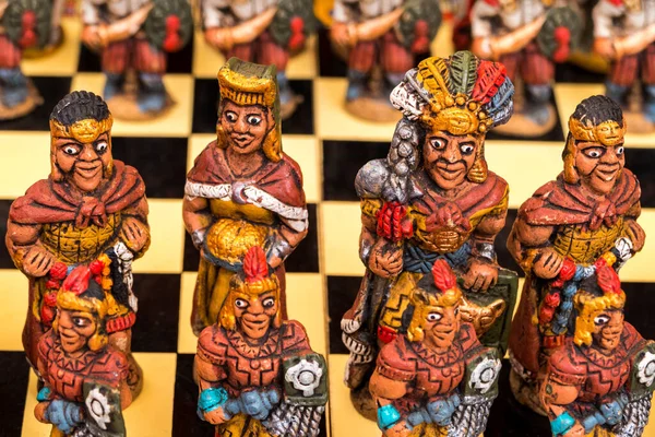 The traditional chess game art and craft product with Spanish against Inca people on a local handicraft market in Pisac, near Cusco, Peru