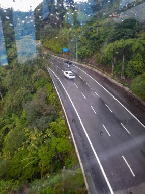 Genting Highland 'e giden teleferiğin Kuala Lumpur Malezya' daki cama düşen su manzarası