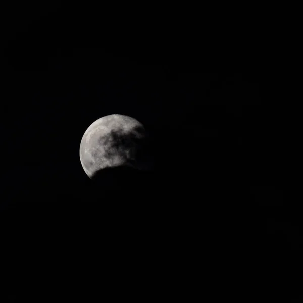 Super Moon in dark night behind the clouds, the moon hide behind clouds during night time