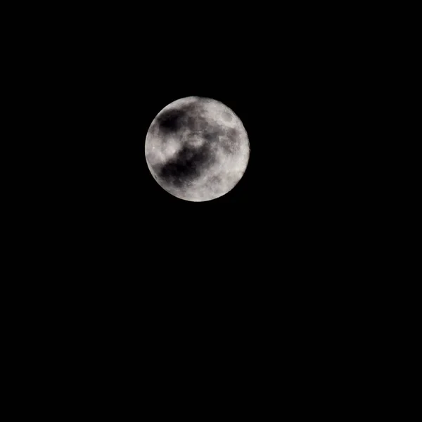 Super Moon in dark night behind the clouds, the moon hide behind clouds during night time