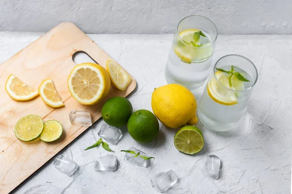 Cold lemonade with ice. Tasty lemonade with lemon, lime and mint.Cold lemonade with ice. Tasty lemonade with lemon, lime and mint. Summer refreshing drink. Top view