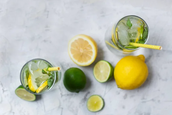 Cold lemonade with ice. Tasty lemonade with lemon, lime and mint.Cold lemonade with ice. Tasty lemonade with lemon, lime and mint. Summer refreshing drink. Top view