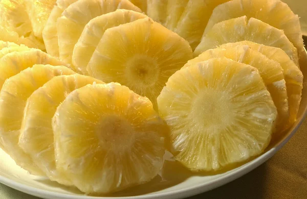 Pineapple. Juice and cut fruit set on the table.