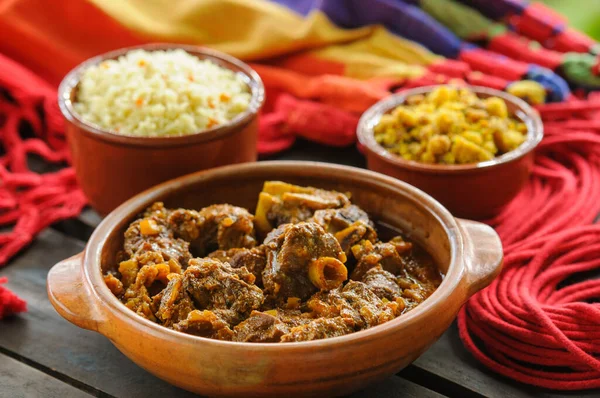 Goat meat in a clay bowl accompanied by rice and manioc flour. Traditional dish of gastronomy from the northeast region of Brazil.