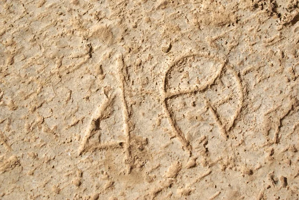 Ancient inscription on the stone surface of the seat number in the amphitheater of Leptis Magna, a former Roman colony in northern Africa.