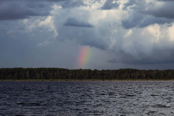 Colorful rainbow after rain above the lake