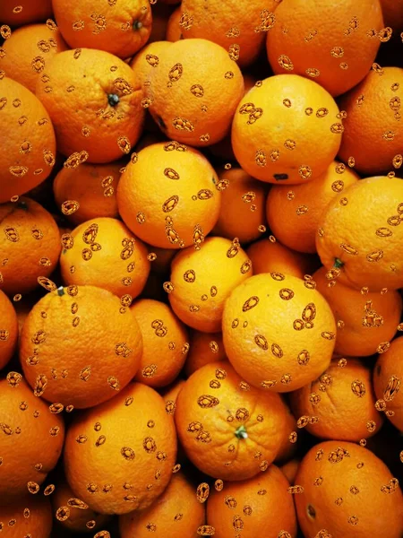 photographic image of many oranges from local market transformed into patterns shapes and designs