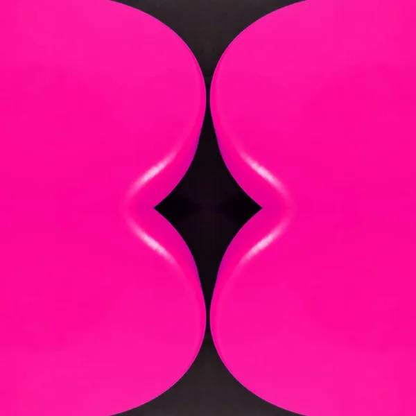 pair mirror image of two vivid bright pink shiny curve shaped tables transformed into e unique unusual shapes patterns and intricate designs