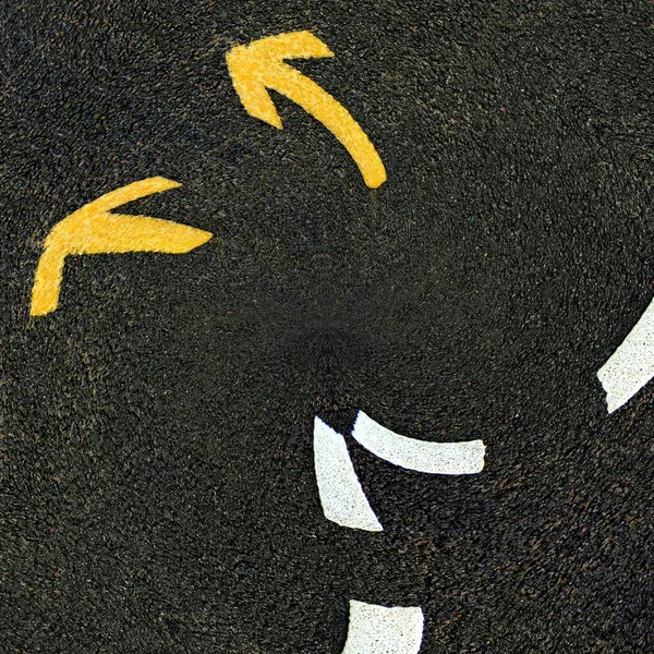 bright white direction arrow and a new black clean asphalt road surface with yellow lane markings
