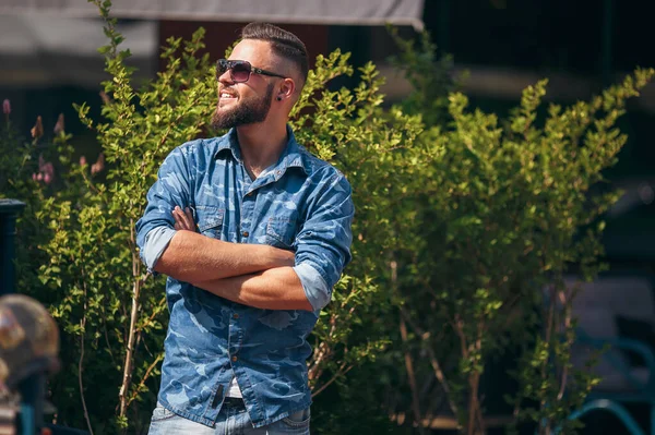 Young guy walking in the spring park. Sunny day. Vesna.Funny guy. A good mood.