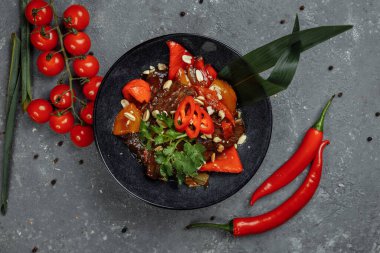 Biftek lokantası. Geleneksel Çin sığır eti kızartması Çin yapımı dökme demir tavada, yemek çubuklarıyla, taş kaplama arka planda. Üst görünüm, alanı kopyala