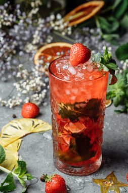 Çilekli Mojito. Soğuk yaz mojito kokteyli. İçinde çilek, nane, limon ve buz var. koyu bir arkaplanda.