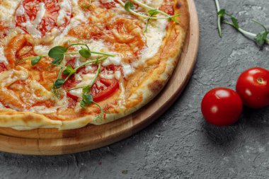 Siyah taş arka planda Pizza Margherita, en iyi manzara. Domates, fesleğen ve Mozzarella peynirli pizza..