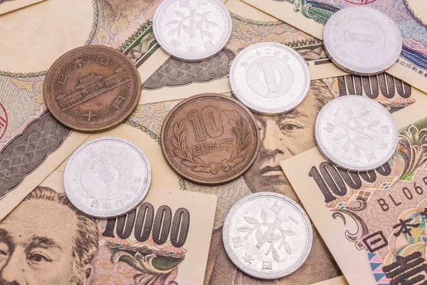 Closeup of Japanese yen banknotes and Japanese yen coin concept background
