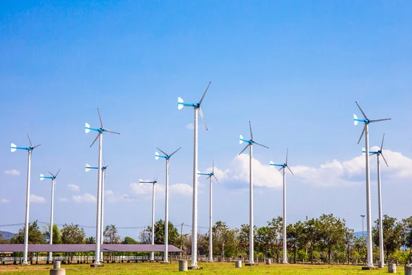 Wind turbines farm eco field in bright day with blue sky background at Chang Hua Man Royal Projects Phetchaburi Thailand.