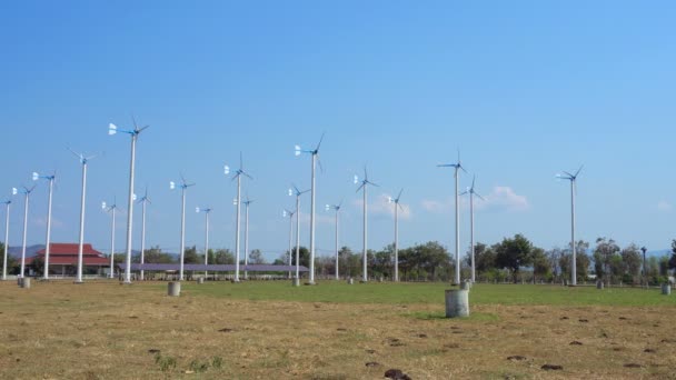 Wind turbines farm eco field in bright day with blue sky background at Chang Hua Man Royal Projects Phetchaburi Thailand. — Stok video