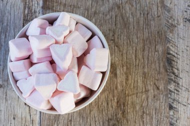 Beyaz kalp yumuşak beyaz lokum kalp ahşap arka planda bir kasede. Alan arkaplanı ve dokuyu kopyala