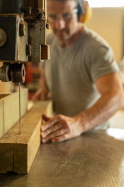 Marangoz bir makineyle odun kesiyor. Seçici odak