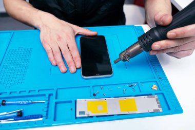 Bir ısı tabancasının telefonu sökme görüntüsü..