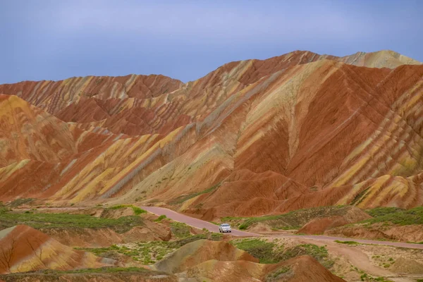 Amazing scenery of Rainbow mountain and blue sky background in sunset. Zhangye Danxia National Geopark, Gansu, China. Colorful landscape, rainbow hills, unusual colored rocks, sandstone erosion