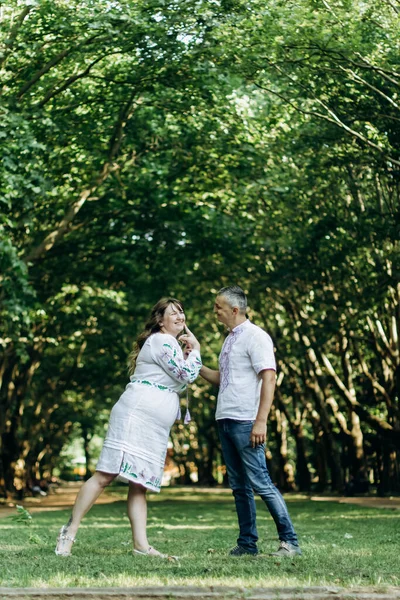 Happy family waiting for baby\'s birth have fun in the park.