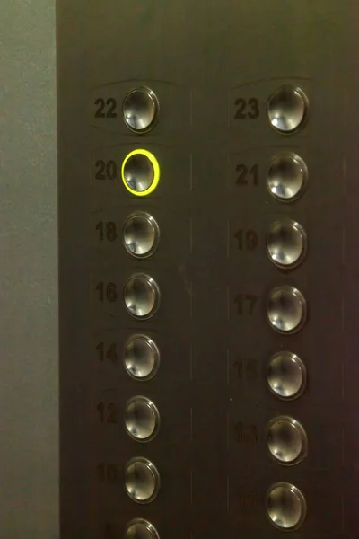 Elevator buttons with number 20 enabled. Keyboard or Elevator control panel. Interior of Elevator in an apartment building. Burning button twenty. Concept of twentieth years 2020