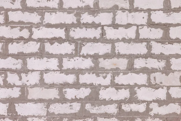Background of white building bricks. Wall is made of white building blocks with elements cement and putty. Textured vintage light background. Architectural pattern. Backgrounds. Concept construction