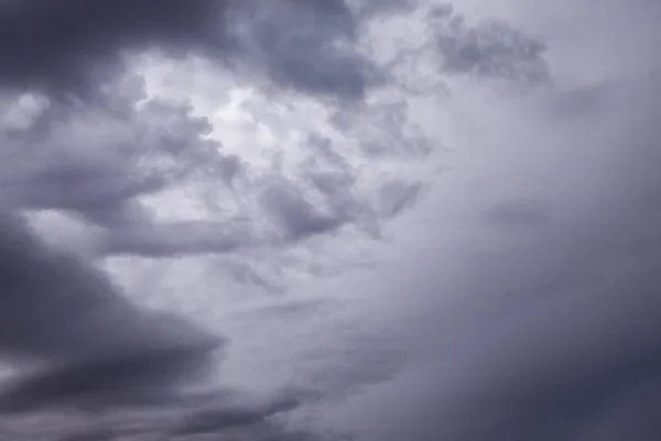 Clouds in blue dark sky. White, fluffy clouds In blue sky. Background nature. Texture cumulus floating on blue sky. Backgrounds concept. Environment, atmosphere. Place for an inscription or logo