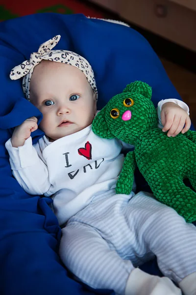 可爱的金发碧眼的小女孩3 4个月大 躺在蓝色毛毯上 带着玩具和微笑 健康童年 养育子女的概念性照片 完美的高加索婴儿 有选择的重点 — 图库照片