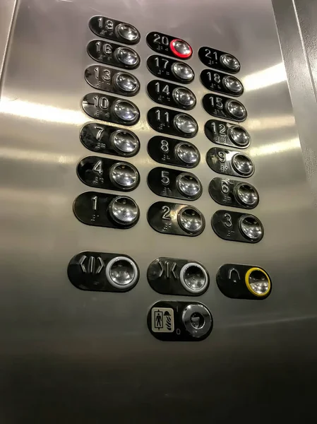 Elevator buttons with number 20 included. Elevator Keyboard made of steel monochrome stainless steel sheet. Close-up of Elevator buttons in multi-storey building. Banner with space for copying text